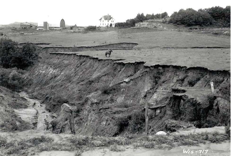 Eroded landscape with lone horse and rider